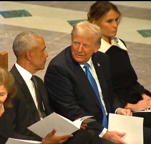 Former President Barack Obama is enjoying a friendly chat with his successor, Donald Trump, while they wait for the state funeral to begin. Former President George W. Bush and his wife, Laura, are on the other side of Obama. Former President Bill Clinton and former Secretary of State Hillary Clinton are on the other side of the Bushes.